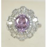 A silver 925 ladies Art Deco style dress ring set with a large oval cut amethyst stone surrounded