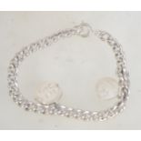 A hallmarked Edwardian silver bracelet with later "Happy Days" spin charm and "21" charm.