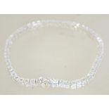 A 925 silver tennis bracelet with hidden clip clasp and safety catch. Weight 14.3g.