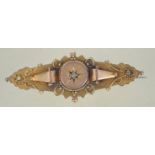 A hallmarked Victorian 9ct gold / 375 Chester hallmarked bar and filigree brooch with inset central