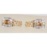 A pair of 9ct gold Art Deco style earrings set with clear stones and post backs. Measures 1.5cms.