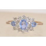 A hallmarked 9ct gold diamond and tanzanite cluster ring. Diamonds 12pts. Hallmarked Birmingham.