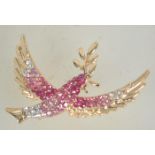 A vintage rhinestone set gold tone figural brooch in the form of a dove of peace carrying an olive