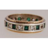 A 9ct gold band ring set with white and green stones. Marked 9ct. Total weight 4.1g. Size L.