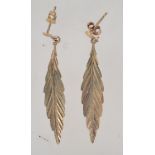 A pair of 9ct gold drop earrings in the form of leaves with post backs. Marked 9ct tests 9ct gold.