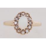 A 9ct gold cluster ring set with opal and a halo of CZ. Hallmarked Birmingham. Size P.