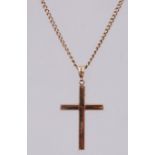 A 9ct gold pendant necklace strung with a crucifix. Measures - chain 20 inches, pendant 4cms.