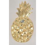 A vintage gold tone figural brooch in the form of a pineapple with safety clip clasp.