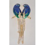 A vintage gold tone enamel and rhinestone figural brooch in the form of two birds of paradise with