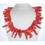 A Large red coral festoon collar necklace with large spring hoop clasp. Measures approx 16 inches.