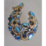 A vintage peacock blue AB rhinestone set brooch pin signed Sphinx with roller clip clasp.