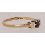A 9ct gold diamond and sapphire trilogy ring. Hallmarked London. Size M.