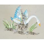 A vintage silver tone and enamel brooch in the form of a swan in flight with marcasite set reeds