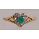 A 9ct gold set with a diamond halo round a green stone in a heart shaped setting.