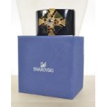 A boxed Swarovski crystal clamper cuff bracelet set with large crystal and enamel stepped Maltese