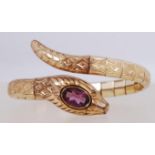 A rolled gold Art Deco articulating wrap around snake bangle bracelet with a bezel set open back