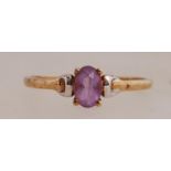 A 9ct gold ring set with a purple gem stone. Marked 9ct. N.5.