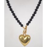 A French jet bead necklace set with a large heart pendant and toggle clasp. Marked Pilgrim.