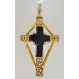 A signed French jet crucifix pendant in a yellow metal mount. Marked Airagle to verso.