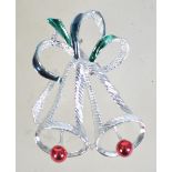 A vintage Christmas brooch in the form of two bells in silver tone metal with a rollover catch.