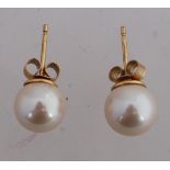 A pair of 9ct gold and pearl earrings. Marked 9ct. Tests 9ct. Total weight 2.7g.