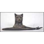 An early - mid 20th century bronze dish in the form of a cat resting upon a fish. Likely a pen dish.