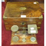 A late-Victorian walnut brass-bound writing box, 30cm wide and a set of brass postal scales and