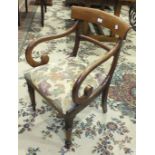 A Regency mahogany scroll arm carver chair with drop-in seat and turned front legs.