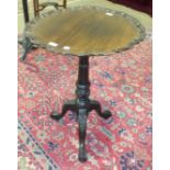 A 19th century mahogany pie crust tilt-top table raised on three claw and ball feet and having a