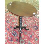 A mahogany oval tilt-top table on triform support, 53cm diameter.