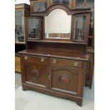 An early-20th century mahogany sideboard, the back fitted with a central mirror flanked by bowed