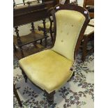 An Edwardian stained walnut upholstered-seat-and-back salon chair on turned front legs.