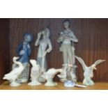 A Lladro seal balancing a ball on its nose, 9cm high, four Lladro swans and three Lladro-style