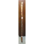 An Oriental carved bamboo walking stick, 86.5cm long.