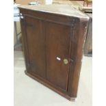 A 19th century oak hanging corner cabinet fitted with single door, 82cm wide, 92cm high.