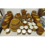 Approximately seventy-five pieces of Hornsea 'Saffron' decorated tea and dinner ware, storage jars