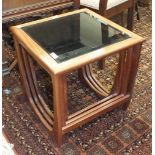 A modern G-Plan-style nest of three tables with smoked glass inserts, 48cm wide and an inlaid