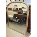 A Victorian gilt gesso over-mantel mirror with arched top, 133cm high, 114cm wide.