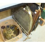 A circular brass-top table with folding wooden stand, a brass mesh fireguard and other brassware.