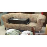 An Edwardian Chesterfield settee on turned front legs, 200cm wide.