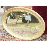 A late-19th century oval gilt-framed wall mirror, 63 x 87cm.