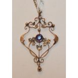 An Edwardian openwork pendant set amethyst and seed pearls, (two pearls deficient), on gold neck