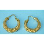 A pair of 22ct gold hoop earrings with raised floral decoration, 2.7cm diameter, 7.4g.