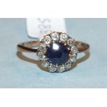 A sapphire and diamond cluster ring.