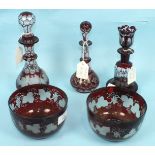 Three Victorian red overlay bottles with stoppers, 19 - 22cm high, a pair of finger bowls and a