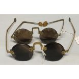 A pair of Chinese quartz sunglasses with brass metal frames and horn disc terminals, 12cm wide, 4.