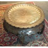 An Oriental white metal shallow tray with central foliate design and embossed border, 66cm diameter.