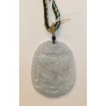 A modern carved jade pendant on braid necklace.