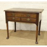 An 18th century walnut lowboy, the cross-banded rectangular top above a brushing slide and three