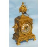 A late-Victorian gilt metal mantle clock, the square case with urn finial, gilt dial and enamelled